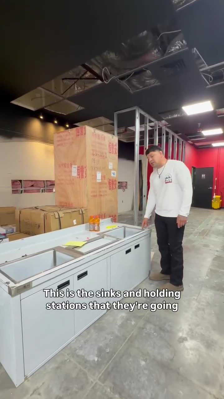 Commercial sinks and holding stations staged for installation in the boba café build-out